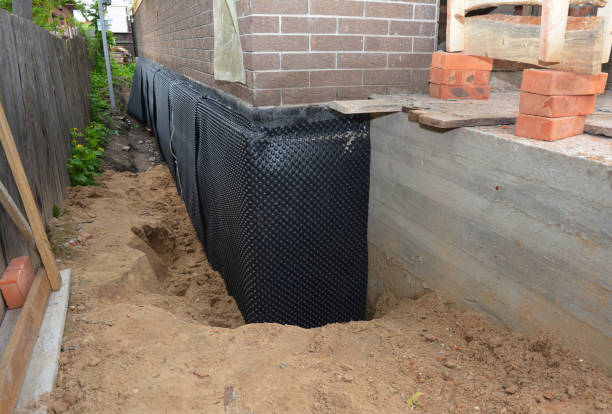 Happy homeowners after waterproofing job in Orange Beach